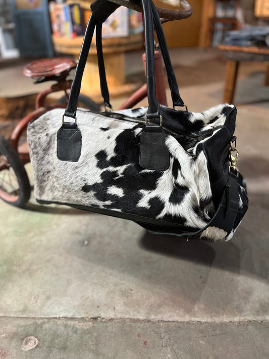 Cowhide duffle with leather strap